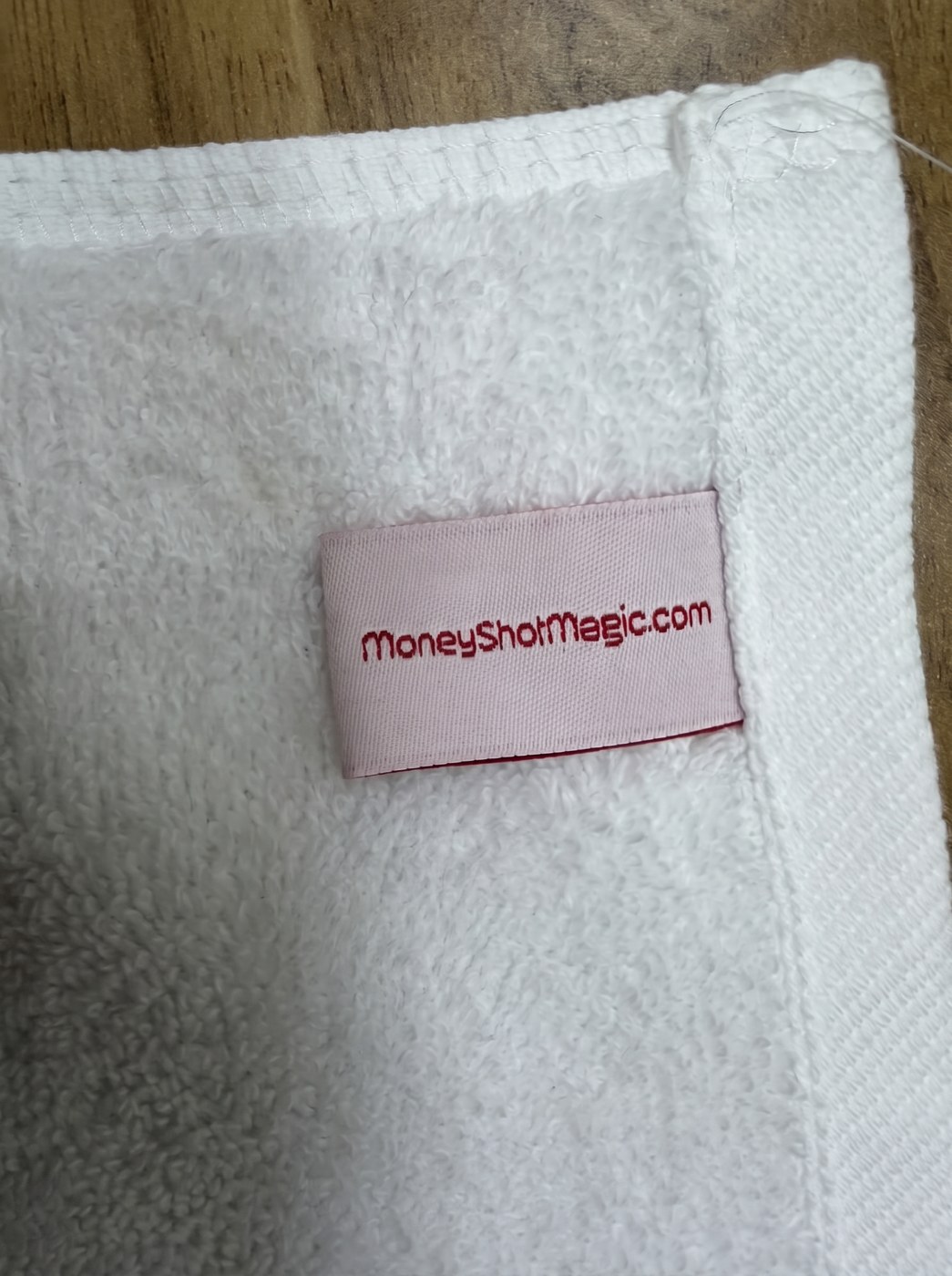 MoneyShotMagic.com woven label sewn into the Mop it facecloth